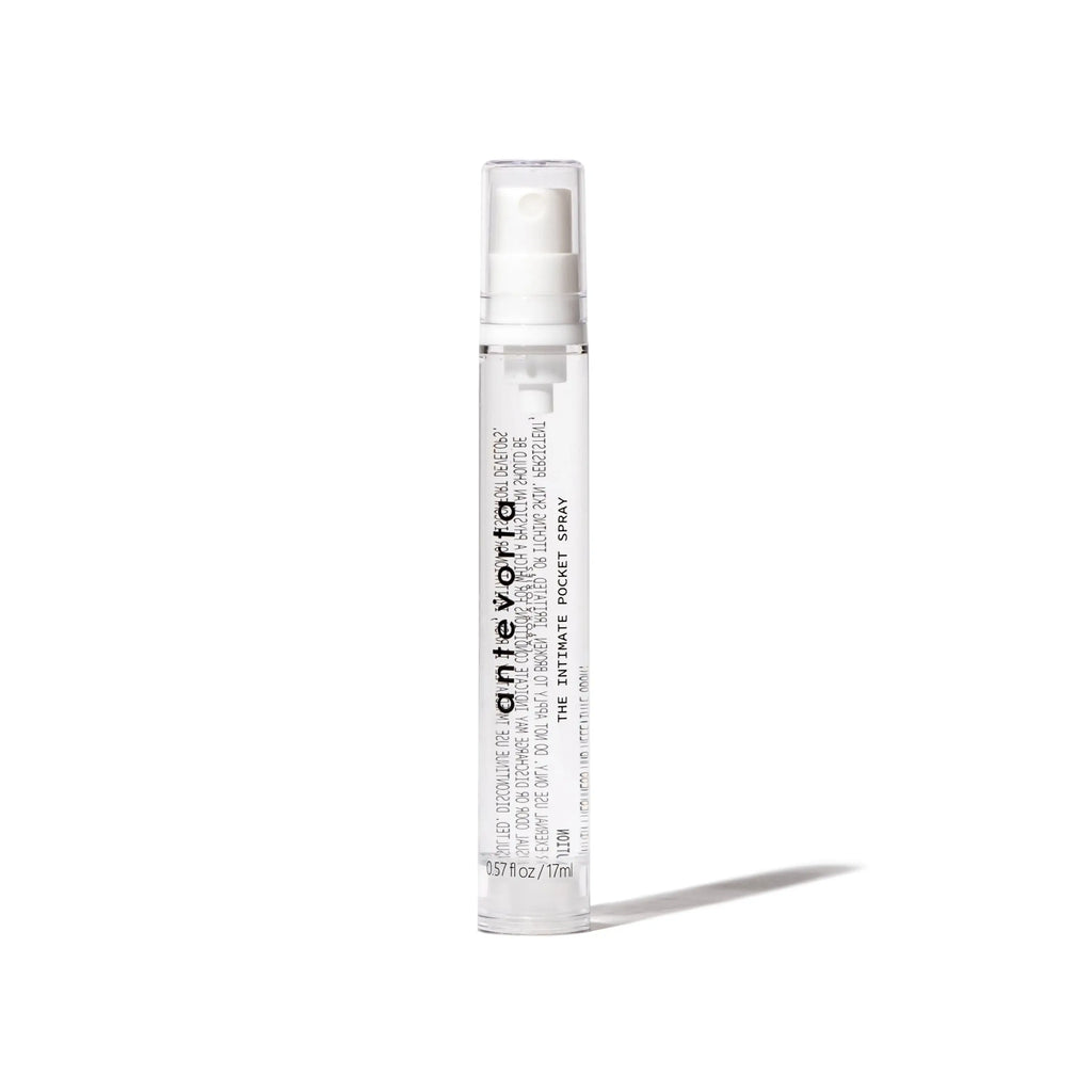 Clear spray bottle with white label on a white background