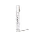 Clear spray bottle with white label on a white background