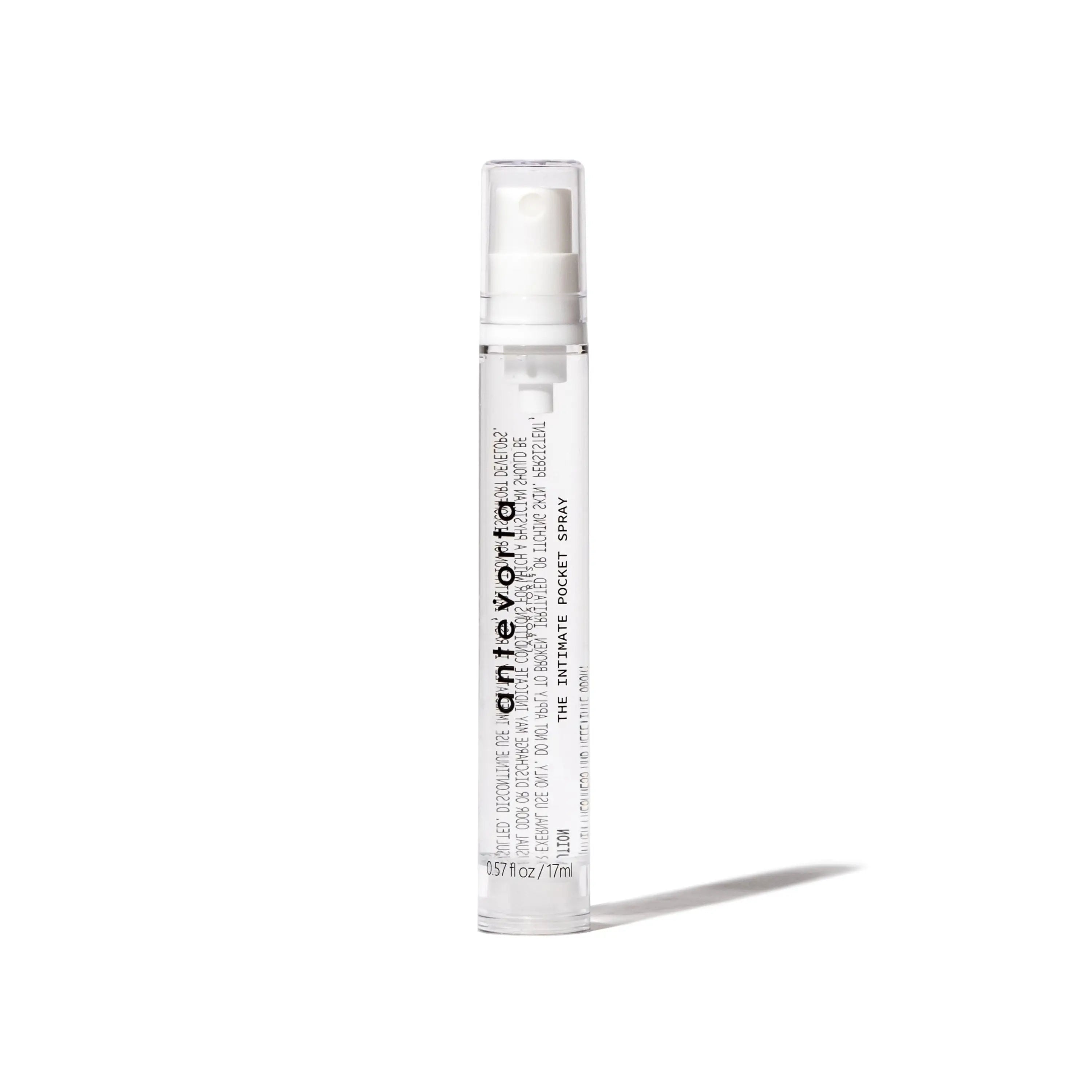 Clear spray bottle with white label on a white background