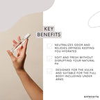 Hand holding a bottle with key benefits listed on a plain background