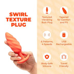 B-Vibe™ b-Vibe Swirl Texture Plug, Medium Vibrating Silicone Butt Orange