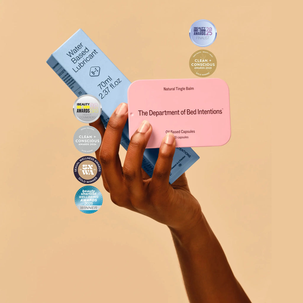 Hand holding a pink card with text against a beige background