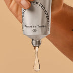 Skincare serum dropper with 'The Department of Bed Intentions' branding on a beige background