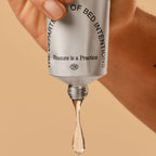 Skincare serum bottle with dropper on a beige background