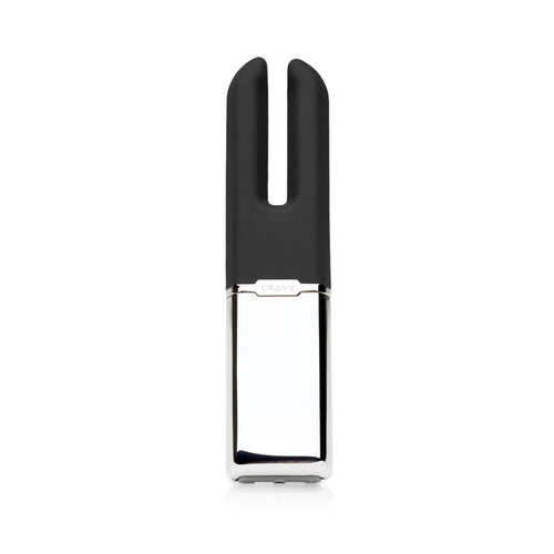 A sleek, modern personal care device with a matte black silicone top and a polished silver metallic body, shown against a solid white background.