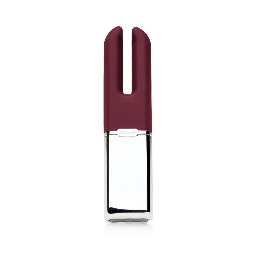 A dual-stimulation personal massager with a dark burgundy silicone head and a polished silver metallic base, shown against a plain white background.