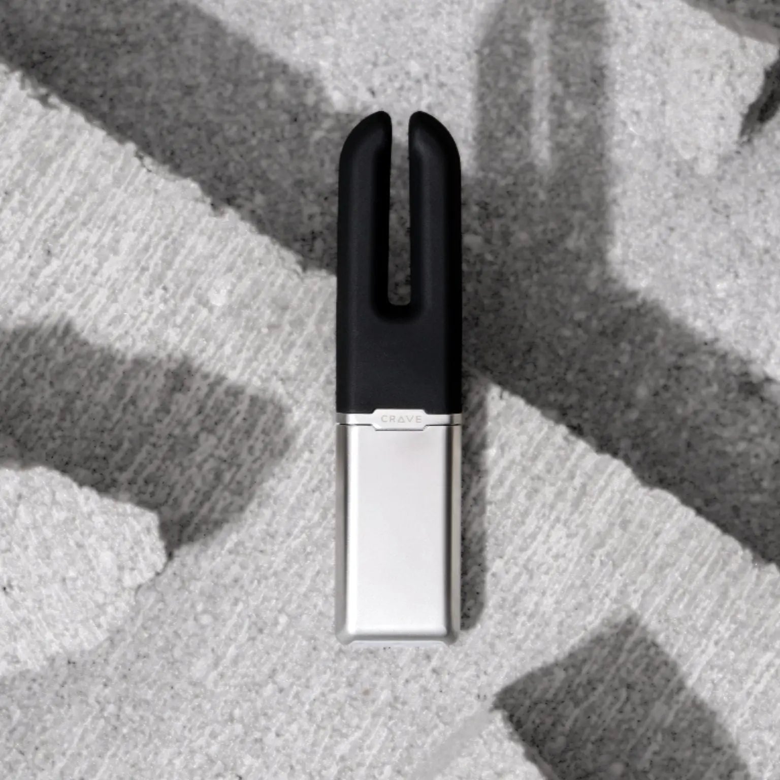 Black and silver clip on a textured surface