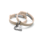 Beige dog collar with silver hardware on a white background