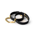 Black rubber bracelets with rose gold accents on a white background