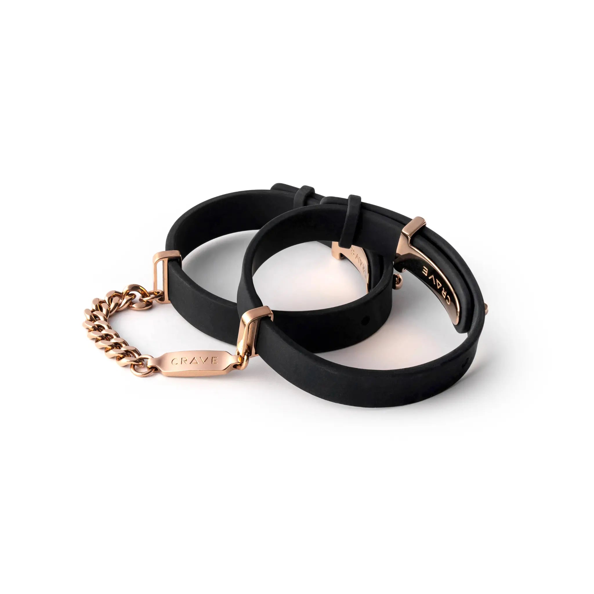 Black rubber bracelets with rose gold accents on a white background