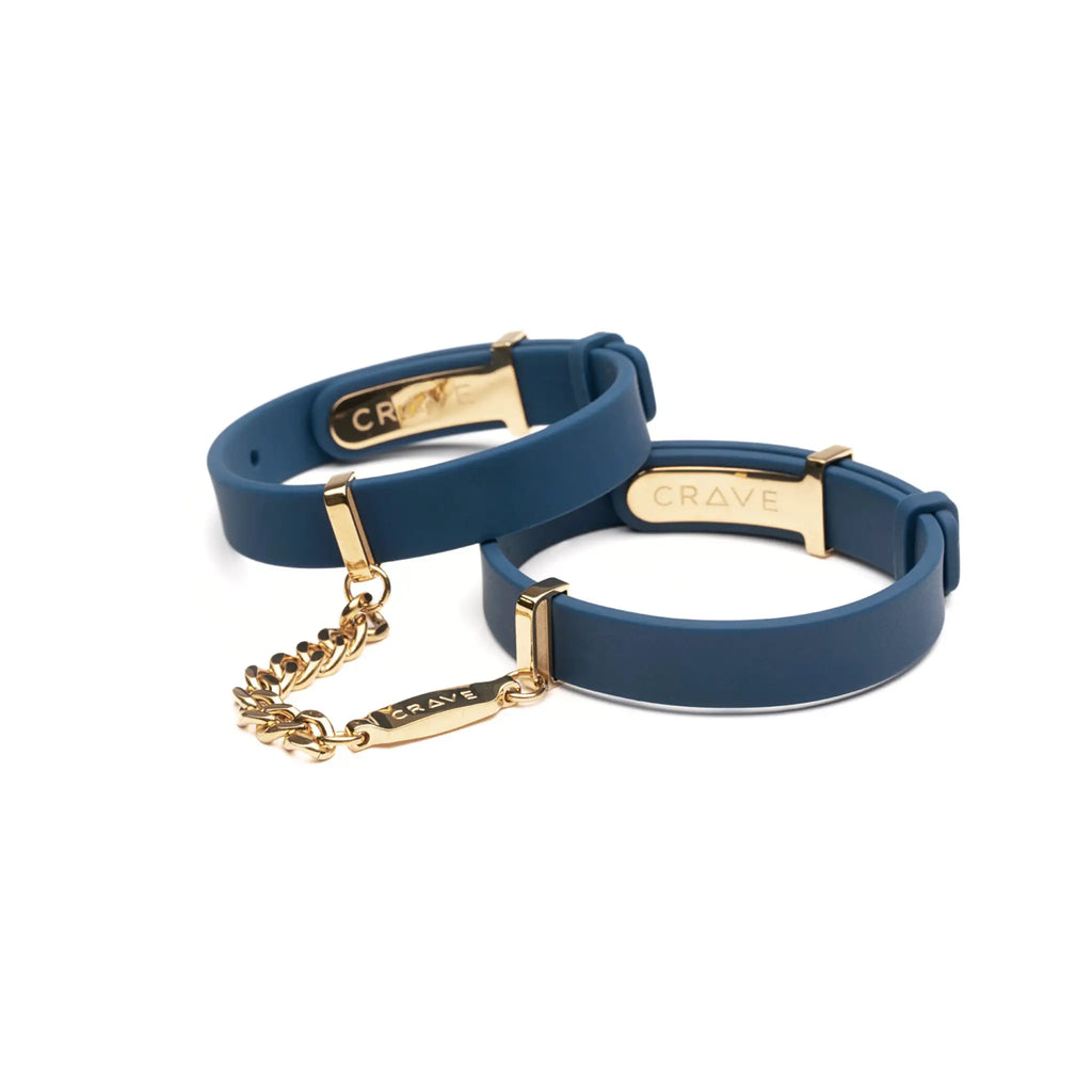 Two blue bracelets with gold accents on a white background, branded 'Crave'.