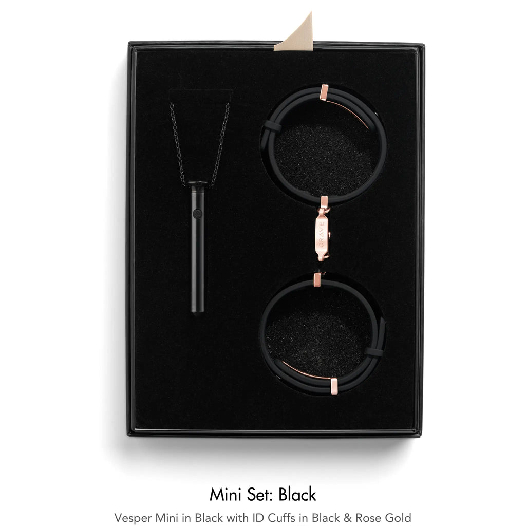 A black jewelry gift set in a black presentation box, featuring a black pendant necklace, a black ID cuff with rose gold hardware, and a black watch with a matching rose gold clasp. The set is displayed on a clean white background with text below reading 'Mini Set: Black'.