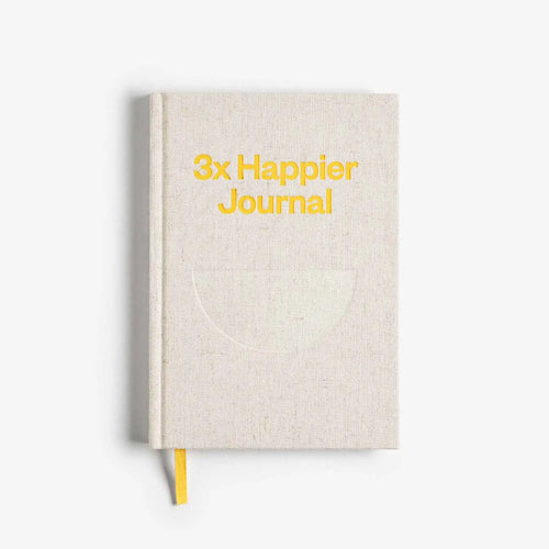 Beige journal with '3x Happier Journal' text on a white background