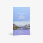 Blue journal titled 'The Five Minute Journal' with mountain and lake design on a white background