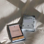 Two books on a textured surface with soft shadows