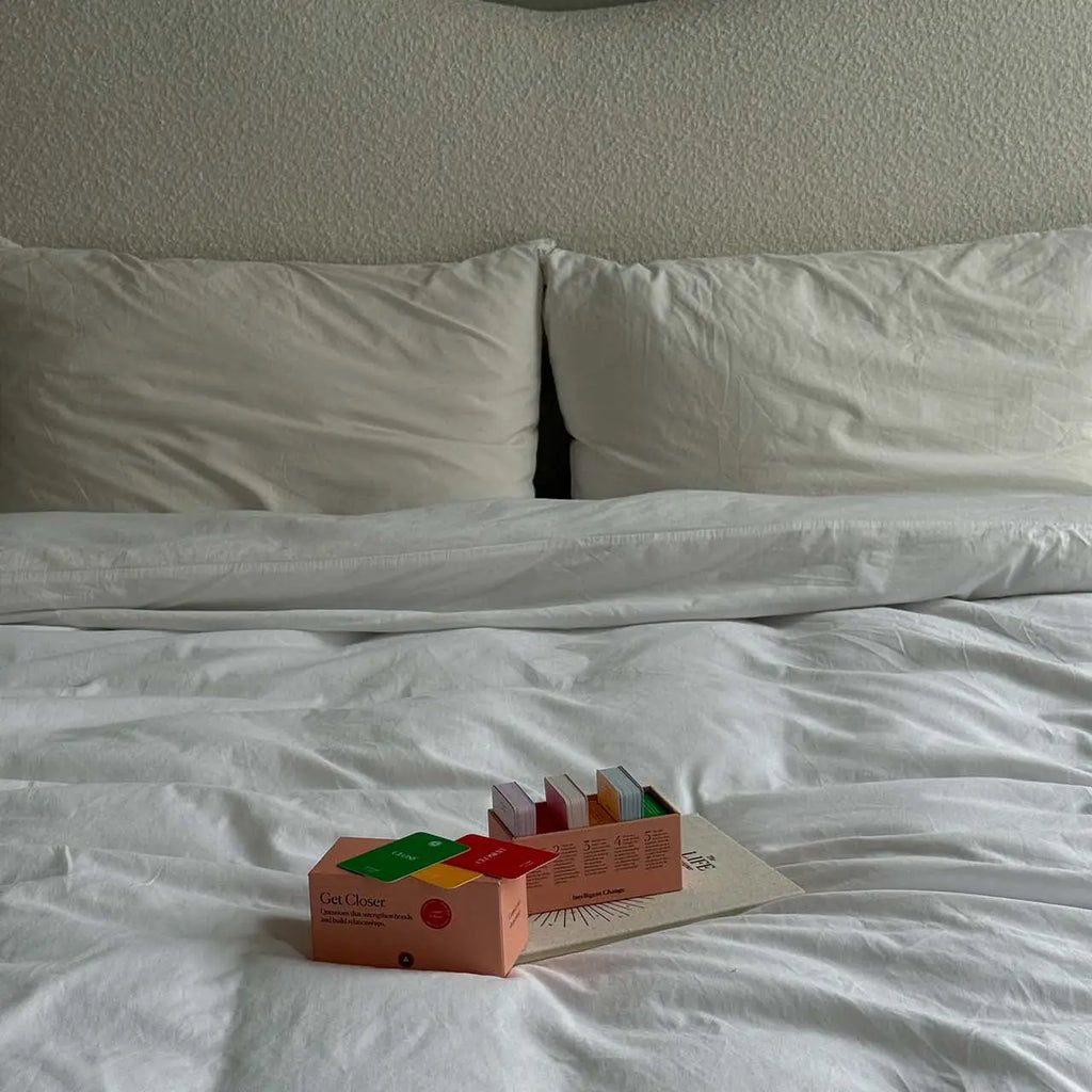 Colorful toy on a white bed with a textured headboard