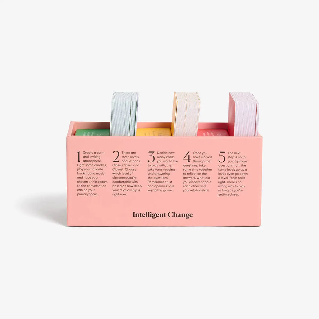 Pink desk organizer with colorful markers and 'Intelligent Change' branding on a white background