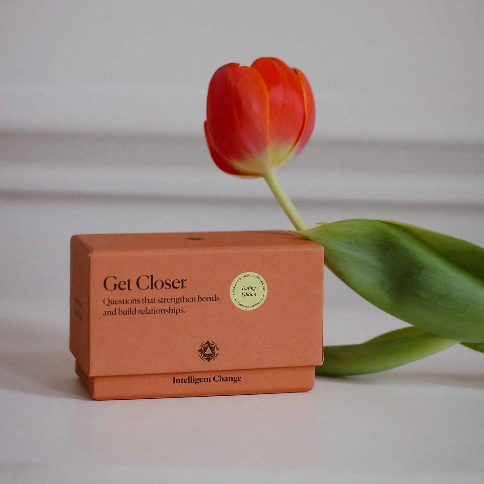 Orange box labeled 'Get Closer' with a red tulip on a light background