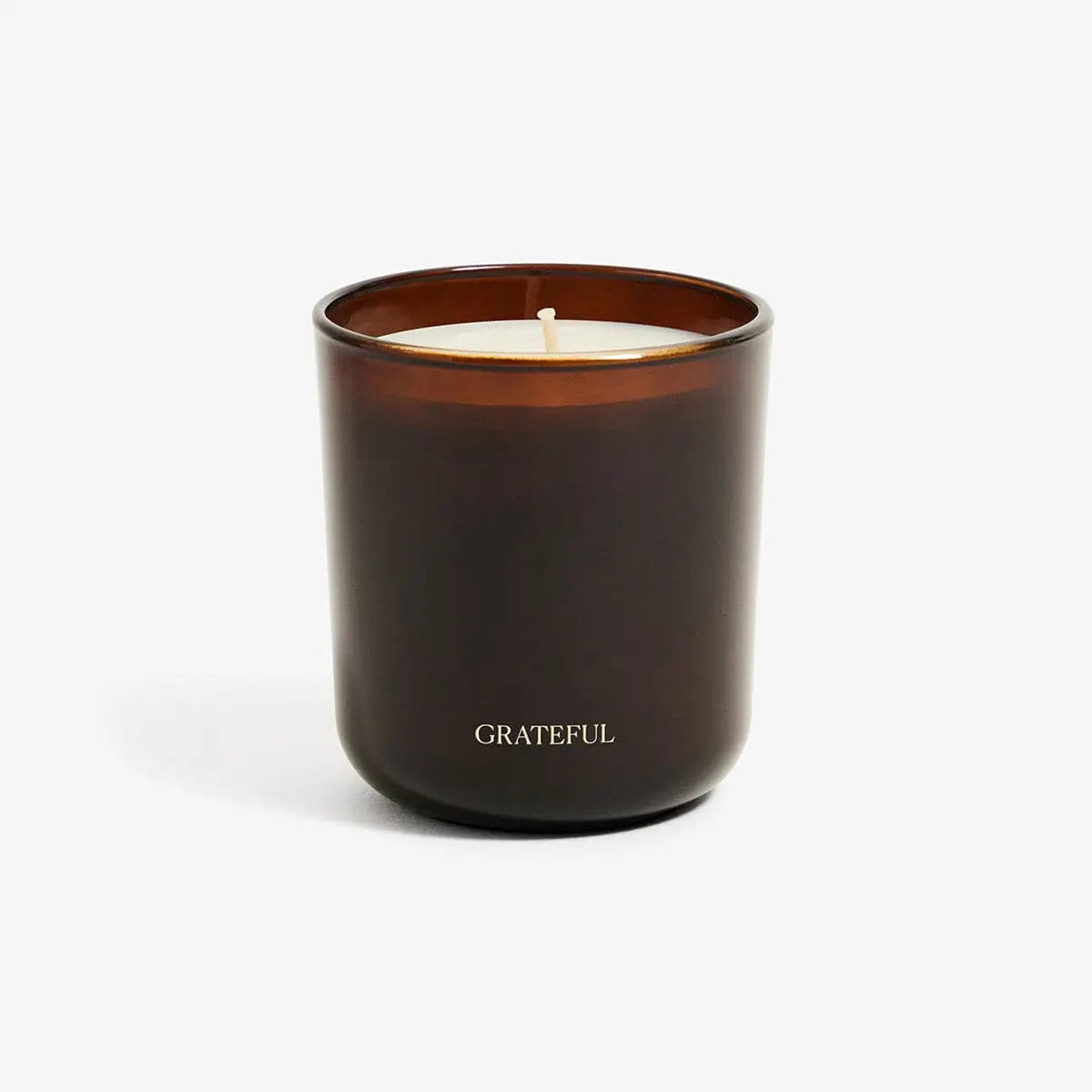 Dark brown candle with 'GRATEFUL' text on a white background