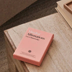 Pink book titled 'Mindful Affirmations Love & Relationships' on a wooden surface.