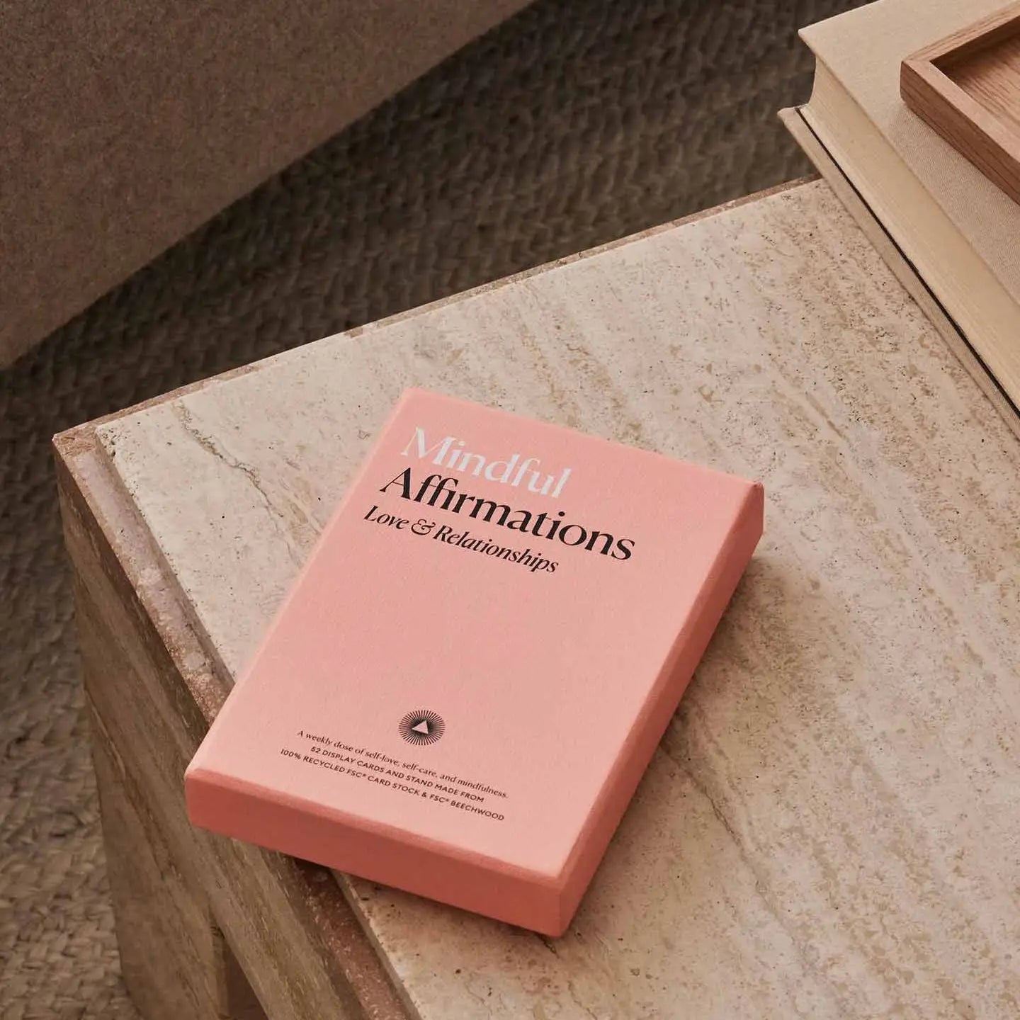 Pink book titled 'Mindful Affirmations Love & Relationships' on a wooden surface.