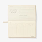  cream colored planner with text and questions on a white background