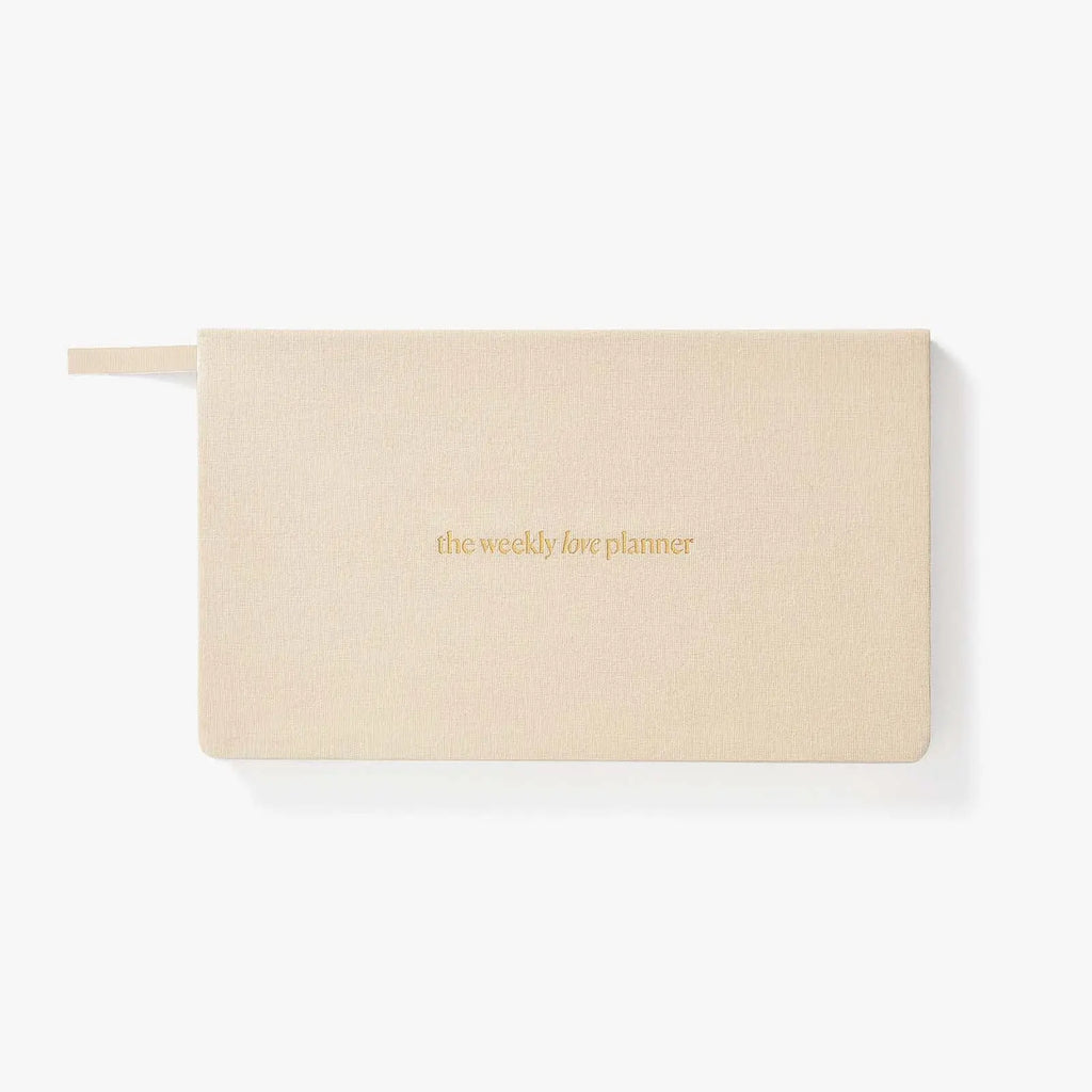 Beige planner with 'the weekly life planner' text on a white background