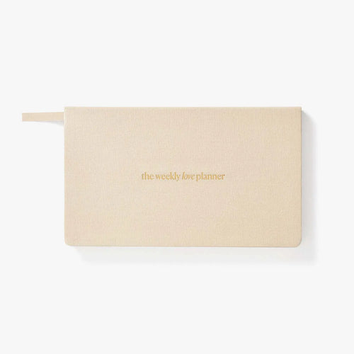 Beige planner with 'the weekly life planner' text on a white background