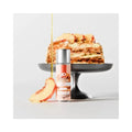 Bottle of JO Bake Shoppe lubricant with peach cobbler in the background
