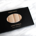 Box of Common Confidential Love Towels on a white background