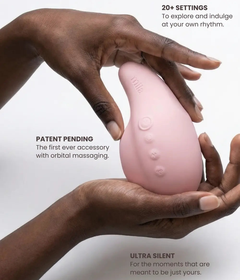 Pink electronic device held by two hands with product features highlighted on a white background