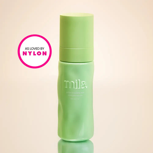 Green bottle with 'mila' branding on a beige background, featuring 'As Loved by Nylon' logo.