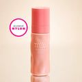 Pink bottle labeled 'mila' on a beige background with 'Nylon' logo.