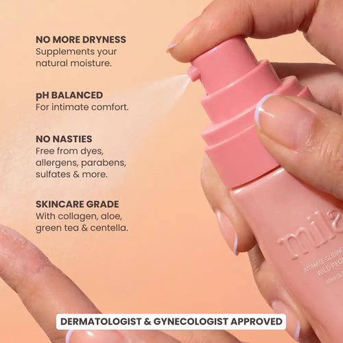 Hand holding a pink skincare spray bottle with product features listed on a peach background